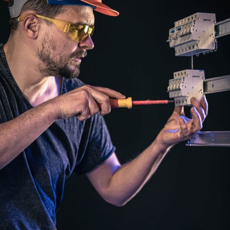 Electrician working on electrical panel